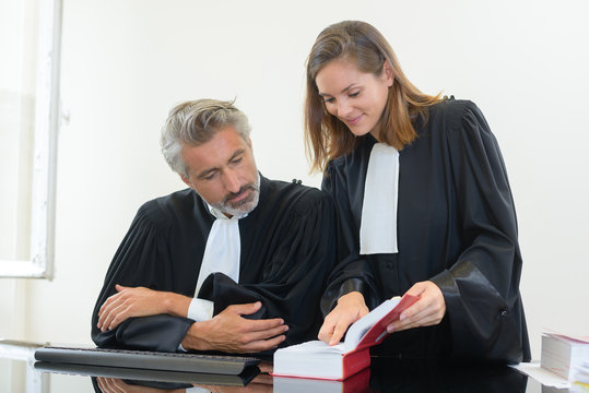 two judges looking at the law book