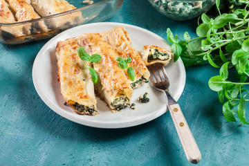 Portion of cannelloni stuffed with spinach