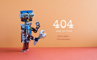 404 error page not found concept. Don't panic I'm a mechanic. Hand wrench adjustable spanner robot handyman, futuristic robotic toy. Brown wall, red floor background.