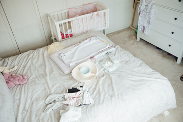 Fototapeta na wymiar Baby Equipment on Parent's Bed