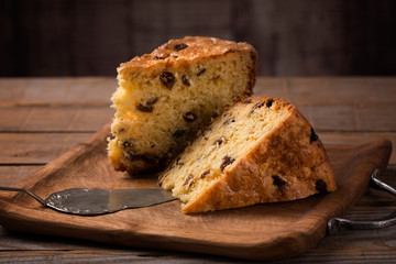 slices of home made cake with raisins on wooden plate