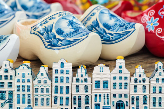 Amsterdam canal houses in front of Dutch colorful clogs