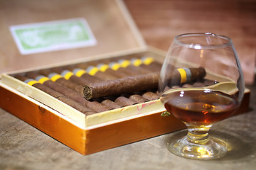 Large box of Cuban cigars on a wooden table