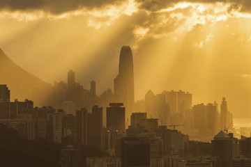 Silhouette of skyline of Hong Kong city with sun ray under sunset