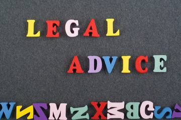 LEGAL ADVICE word on black board background composed from colorful abc alphabet block wooden letters, copy space for ad text. Learning english concept.
