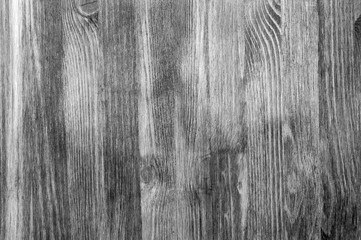 Black and white textural background of wooden boards arranged vertically.