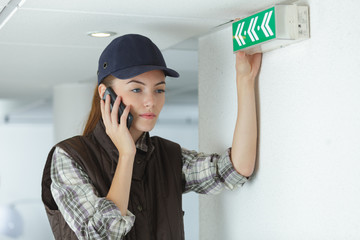 female engineer talking at mobile phone on construction site