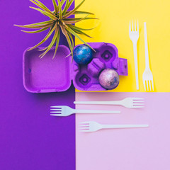 box with crazy magic dragon eggs with cosmic pattern on geometric background with plastic forks. art creative concept. minimal and surreal artwork