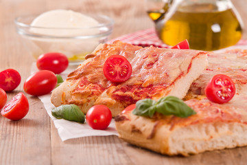 Italian pizza with cheese, tomatoes and fresh basil. 
