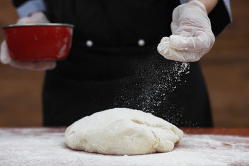 the cook makes flour for baking on the table