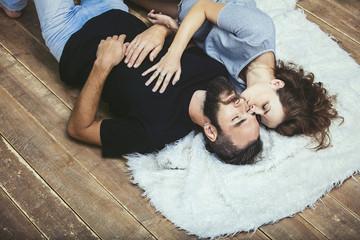 Heterosexual couple young beautiful man and woman on wooden floor background