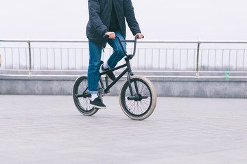 BMX cyclists ride a bike on the square. BMX concept