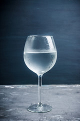 Cold water in glass on the rustic background. Selective focus.
