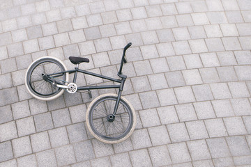 The BMX bike lays on the ground a top view. Copyspace.