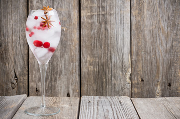 Gin with cranberry and ice in wine glass. Selective focus.