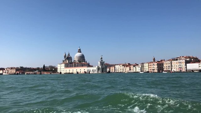 view from the water of Basilica Santa Maria della Salute and Dogana, old custom house, old town of Venice, Italy