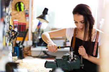 Young woman working in a bicycle repair shop
