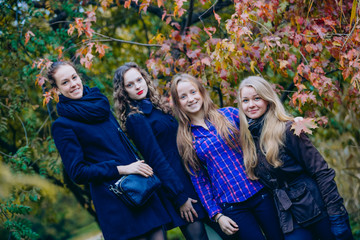 Female students strolling in the Park in autumn