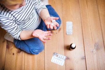 Toddler boy in a dangerous situation at home.
