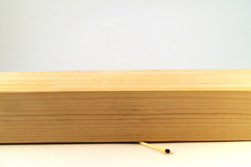 One thin match, crushed by a thick board.