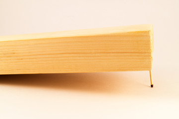 One match holds a thick wooden board from falling to the surface.