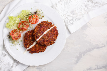 Vegan burgers from lentils, oats and vegetables. Veggie cutlets served with green salad and...