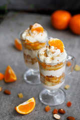 Dessert in a glass with tangerines and whipped cream
