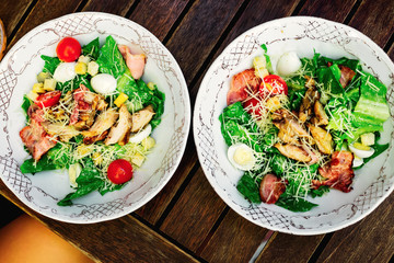 Top view of a delicious and useful salad with bacon and fresh vegetables