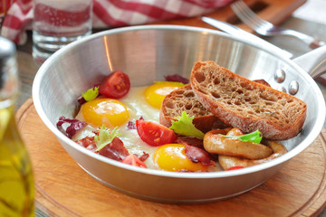 Scrambled eggs on the wooden table