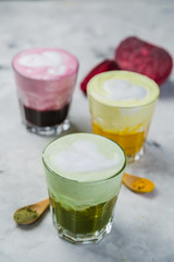 Selection of colorful super lattes on marble background