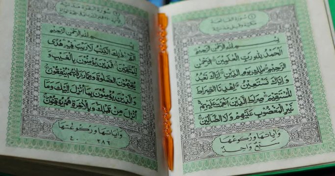 Closeup of Koran or holy book of Muslims with pointer stick in the mosque open for prayers. Shot in 4k resolution