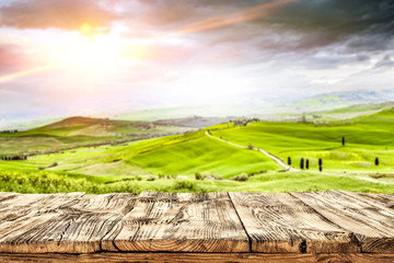 Fototapeta na wymiar spring background of desk and tuscany landscape 