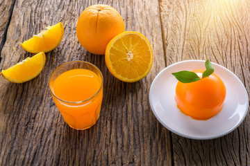Orange cake and Glass of Fresh Orange Juice on grunge wooden table