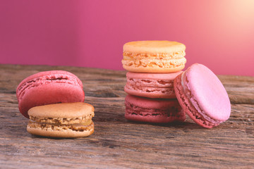 Different types color of macaroons on Old grunge wooden background
