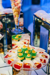 Close view of a piece of a colorful jelly cake with fruits