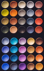 Colorful eyeshadow set on a black background.