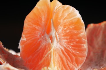 Orange peel mandarines on a dark background on a wooden table. Tropical fruits. Closeup for concept design.