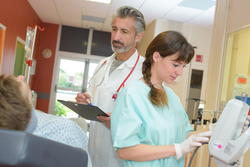 male doctor and nurse visiting patient at the hospital