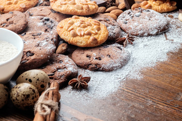Chocolate chips cookies and peanut cookies on dark rustic texture with copy space for your text. close-up view.