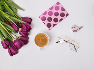 Coffee and beautiful purple tulips