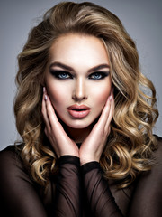 Closeup face of a beautiful girl with  makeup in style smoky eyes.