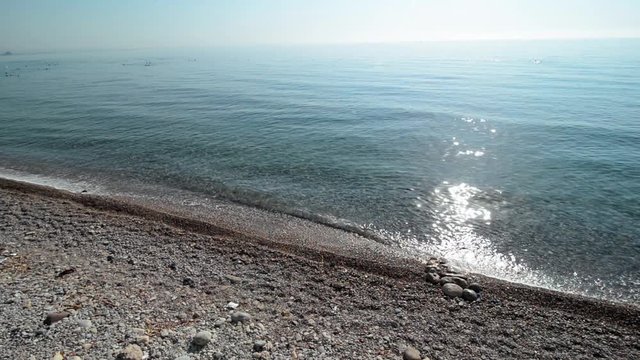 Turkey - August 2017, Kemer, Beldibi: Empty stone beach and waves splash on the shore. Top view from high 