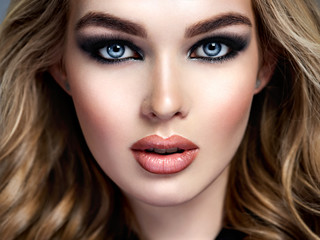 Closeup face of a beautiful girl with  makeup in style smoky eyes.
