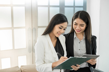 Young asian businesswoman in modern office, discussing business with colleague during meeting and interview