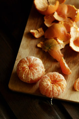 A pair of peeled tangerines on a wooden board