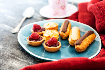 Mixed dessert Raspberry tartlet, Eclair Puffs, almond lemon