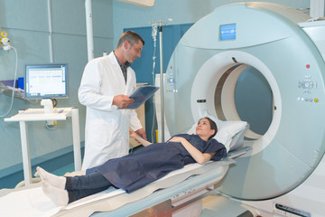 female patient talking to doctor before mri scan - obrazy, fototapety, plakaty