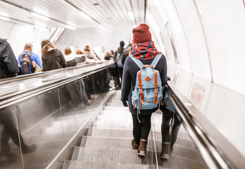 People stand on the escalator in the metro or subway, the concept of public urban underground transport © EdNurg
