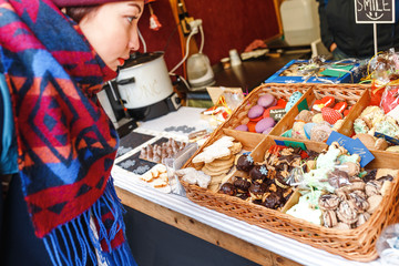 Girl looking at the different of cakes at Christmas market