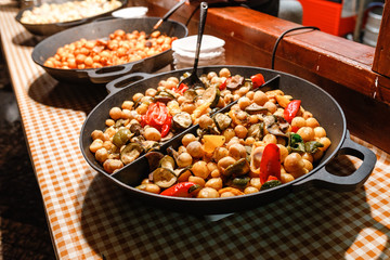 street food for sale, hot pot with fried potato and mushrooms